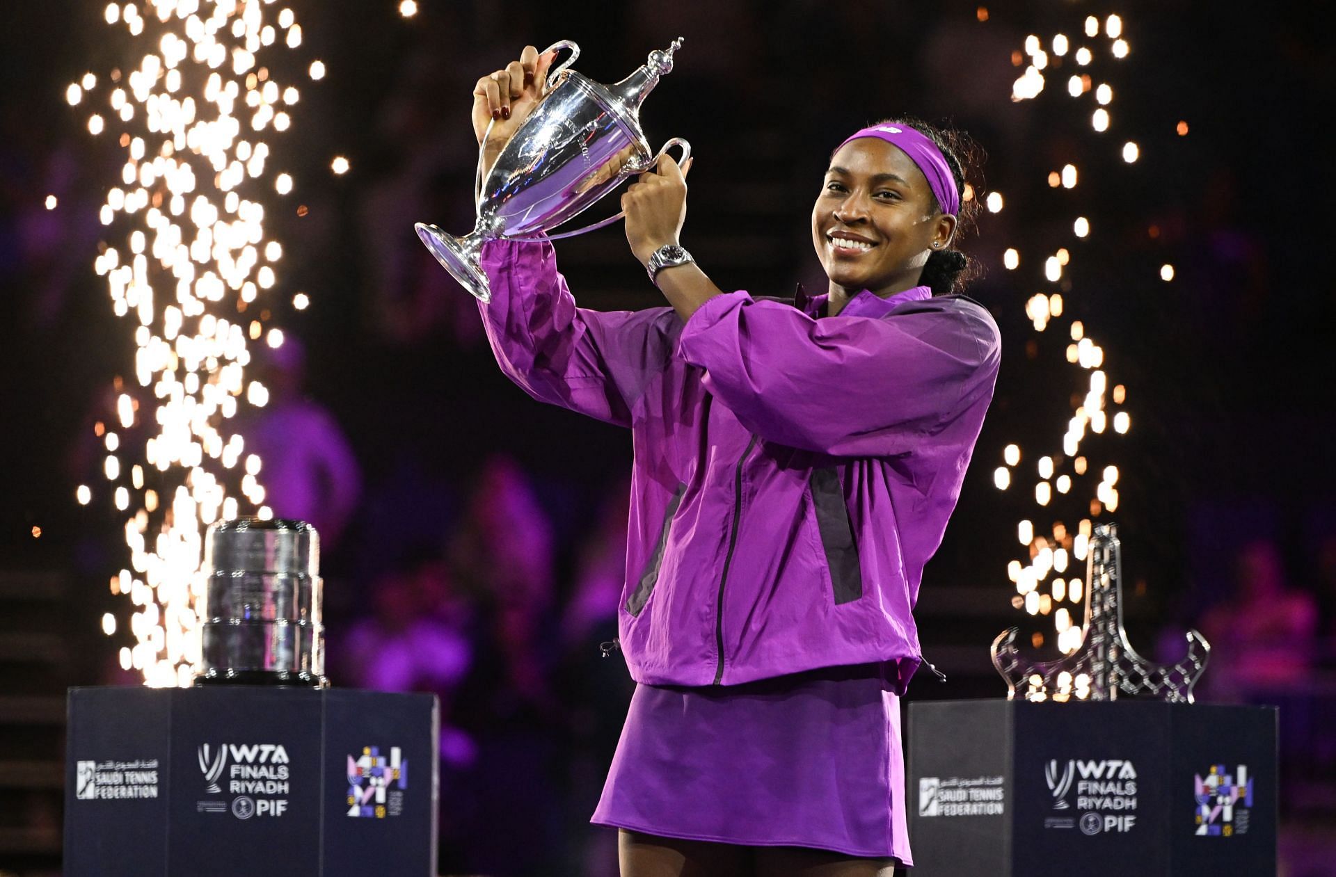 Coco Gauff poses with the WTA Finals trophy in Riyadh